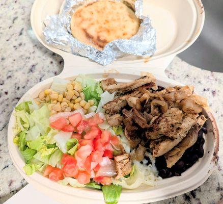 Chicken Arepa bowl (no plantains) - rice, black beans, cheese, corn, onion, lettuce and tomato, and comes with a cheese arepa (back).