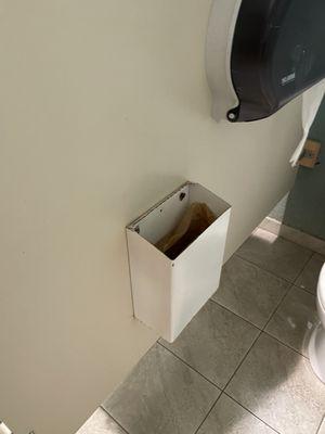 Male worker in women's locker room, no barriers, open broken Kotex box