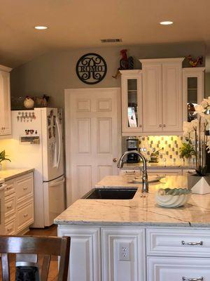 Full kitchen remodel.  New cabinetry, countertops, backsplash, sink and flooring.