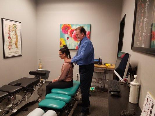 Dr. Hoffman examining a patients spine.