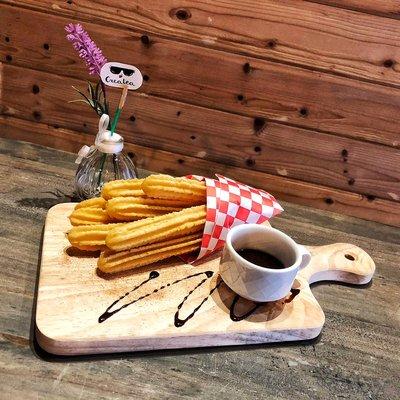 Baked churros with your choice of sauces.