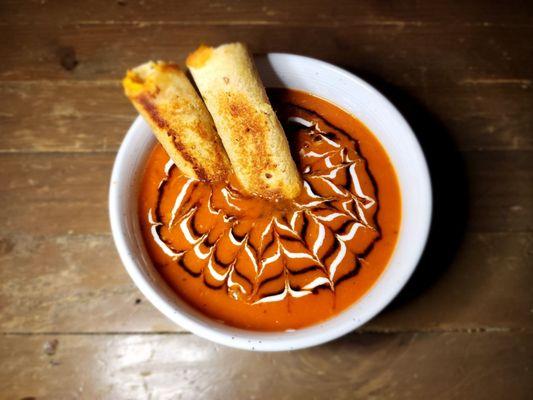 Tomato soup with grilled cheese rolls. Balsamic & cashew crema drizzle
