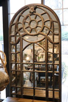Just imagine how this dramatic mirror--inspired by cathedral windows--would bring light and life into your space. 