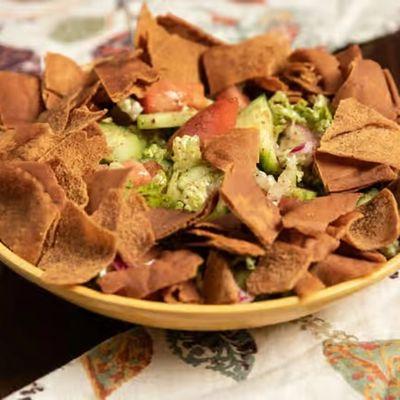Fattoush Salad (Vegan)
Crisp romaine, tomatoes,
cucumbers, red onions, pita chips,
and pomegranate molasse