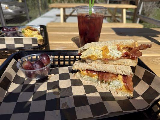 Breakfast sandwich on sourdough with a prickly pear ice tea