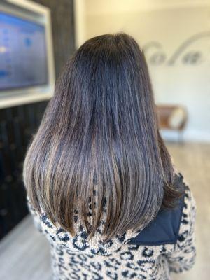 Full head of tape-in extensions for a woman in her 70's.