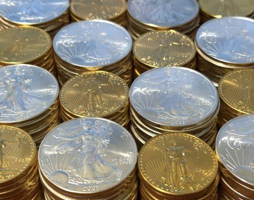 Stacks of gold and silver American Eagles.