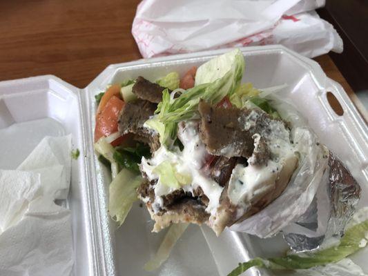 Gyros combo with salad vs fries and menu board.