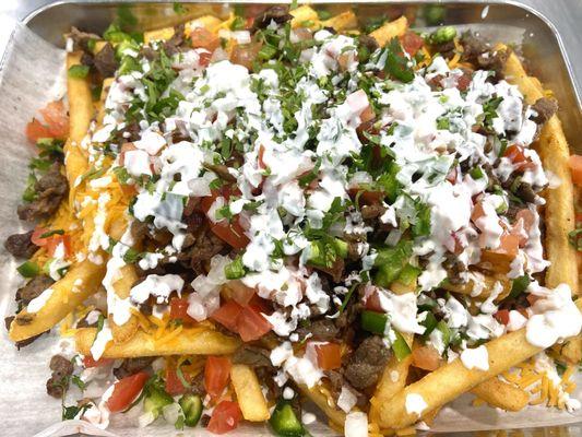 Carne Asada Fries with everything on it; Sour Cream, Pico, jalapeño's. 10/10