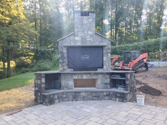 Outdoor entertaining space paver patio, tv and fireplace