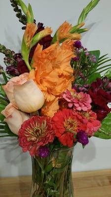 As close to the original arrangement as possible, in a vase.