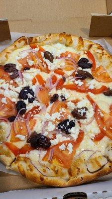 Greek pizza with olives, feta, tomatoes and onions. Delicious!