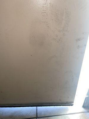 Filth and foot prints on door