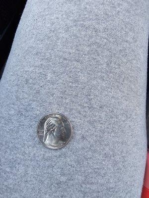 A quarter that has the word hope on it with a mans face in the o.