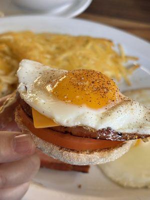 Another sunny side egg on top of English muffin, ham (from ham and eggs plate), sliced tomatoes, and slice of American cheese!