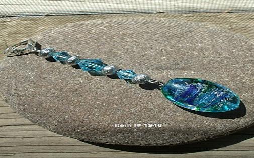 Oval aqua glass drops swirled with silver and dark blue, matte silver round, and topaz-blue Swarovski crystals, 3-1/4" long