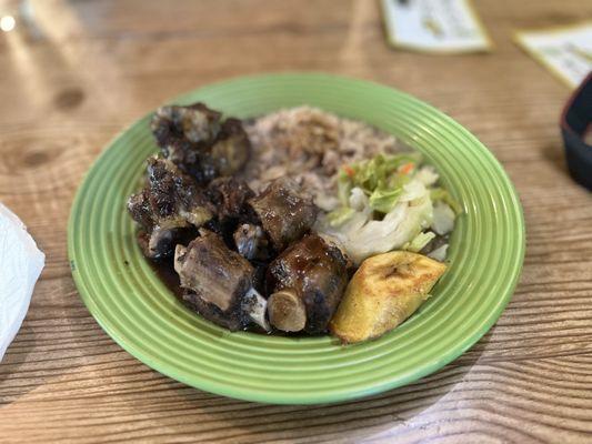 Oxtail, plantain, salad, beans and rice