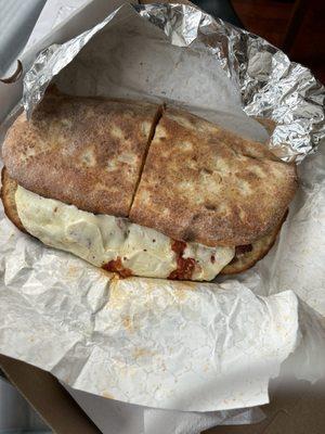 That right there is a monstrously hug and delicious chicken parmigiana sandwich. No way be person can eat this. Half would feed me twice.