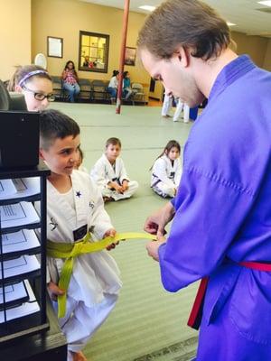 My son being rewarded his stripe.