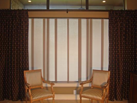 Skyline Gliding Window Panels may be tucked behind the decorative embroidered drapery panels, or closed for privacy.