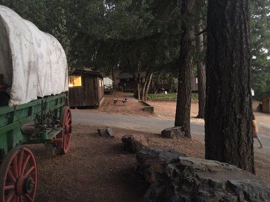 View of the Cedar House and covered wagon in the evening.