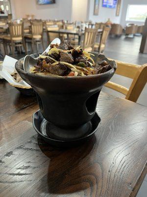 Heavy sizzling bowl for the hot beef and onion dish.