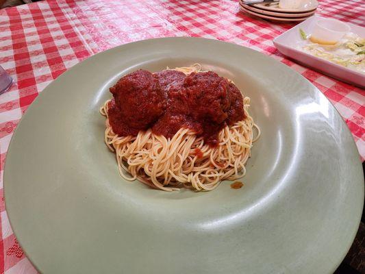 Angel hair pasta with red sauce and meatballs.