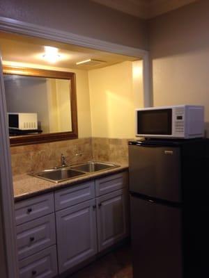 The kitchen is both modern and functional, fringe, freezer, microwave and all. If the add a gas range they could double the rate.