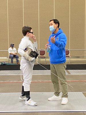 Coach Young guides Lex in the Y10 epee national tournament.