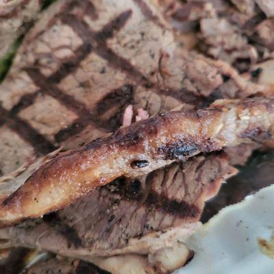 Thick gristle flap on meat, not trimmed before cooking