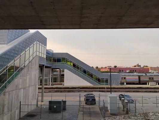 View of escalators and covered walkway from station to train. If you requested assistance or are disabled, porters will provide a ride.
