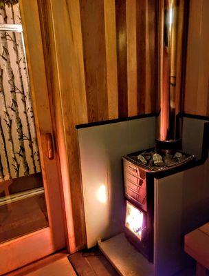 The glow from a woodburning sauna stove.