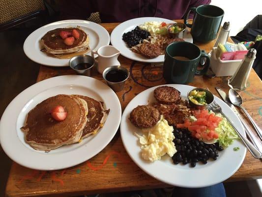 Blue corn cakes with eggs, black beans, salsa and a side of turkey sausage.