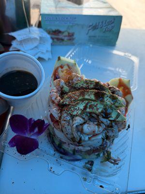 Tostada reyna ; shrimp ceviche, scallops, cooked and raw shrimp, octopus, with our special home black sauce.