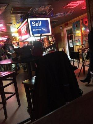 Pool table lit up by a gas station pump light