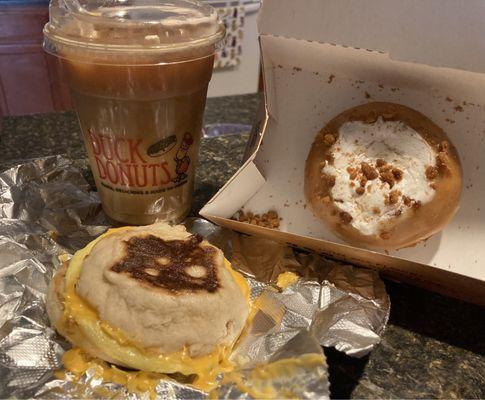Egg and cheese sandwich, Iced caramel macchiato, and buttercream donut