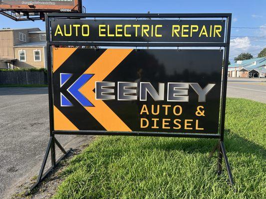 Street-side sign for Keeney Auto & Diesel in Soddy-Daisy, specializing in advanced auto electric repair and diagnostics.