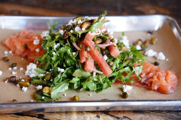 Watermelon Smoked Salmon Salad with arugula, fried capers, toasted pistachios, goat cheese with a jalapeño vinaigrette