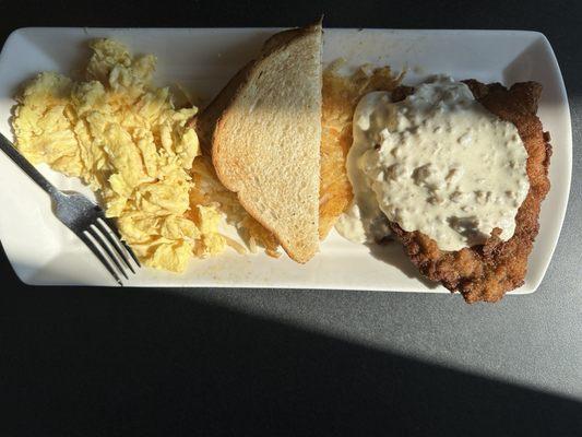 Chicken fried steak, scrambled eggs, hash browns, and sourdough toast