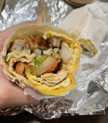 Breakfast burrito with sausage, egg, veggies and cheese