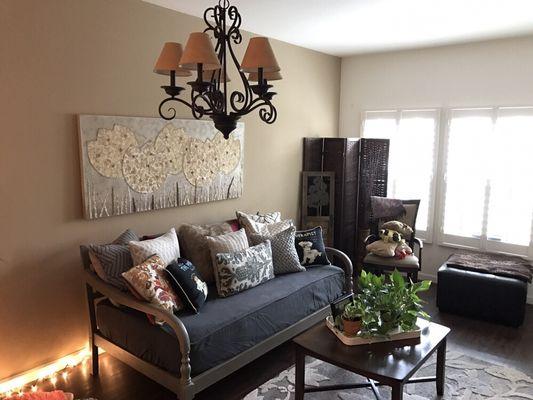 Nice accent wall, chandelier, art work and very nice furniture setup, Sylvia Lazalde