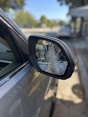 A broken passenger view mirror on 2022 Volkswagen atlas .