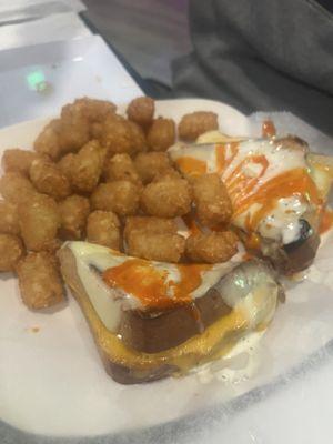 Grilled cheese smoothered with buffalo and ranch and side of tater tot's.