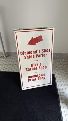 Inside the basement entrance is a sign board directing you to Nick's.