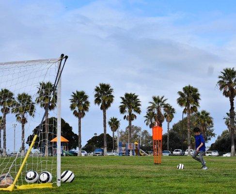 This youth player is learning to shoot with correct form. There are many technical cues in proper kicking so 1on1 attention is very helpful.