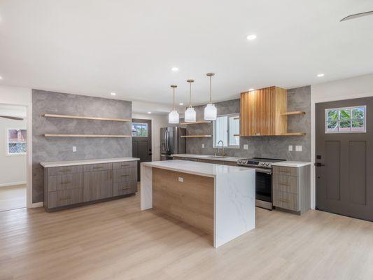 Waterfall quartz island built for entertaining--custom kitchen at its best.