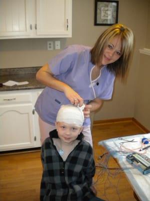 One of our techs setting up an in-home EEG on a child