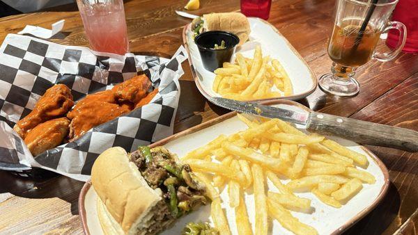 Philly cheesesteak with chiles, mushrooms, and jalapeños, fries, wings with buffalo sauce, hot toddy and blackberry lemonade