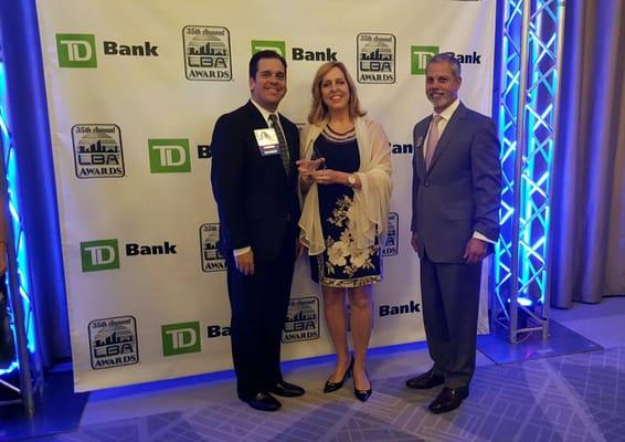 Jorge Martinez and C.L. Conroy receive the "Best Agency of the Year Award" from the Latin Builders Association.