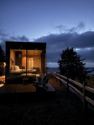 Exterior at night, with shades up you can see directly into the cabin